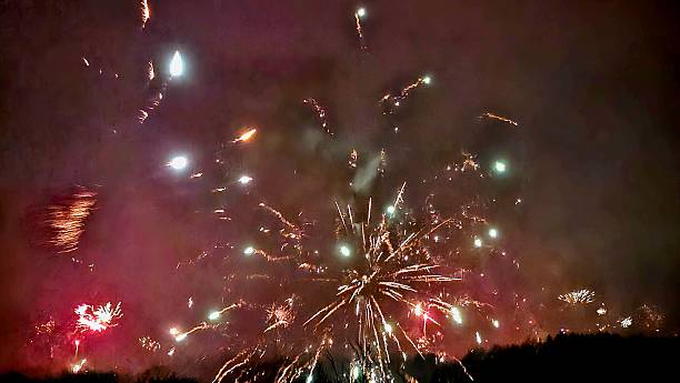 istock New Year's Eve fireworks over dark silhouette 2254608392