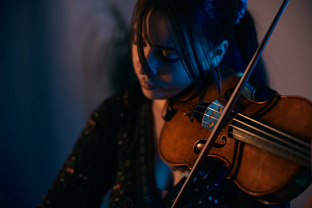 artist and her violin share a silent dialogue, a moment captured where music speaks louder than words