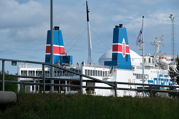 Nynashamn, Stockholm County, Sweden - June 11, 2025: A large blue and red ship is docked at a pier. The ship is a ferry