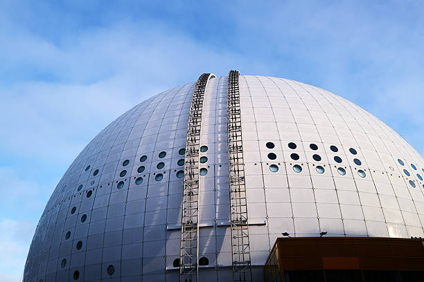 Stockholm, Sweden - December 22, 2025: A large white building called Globen with a blue sky in the background. The building has a lot of windows and looks very impressive