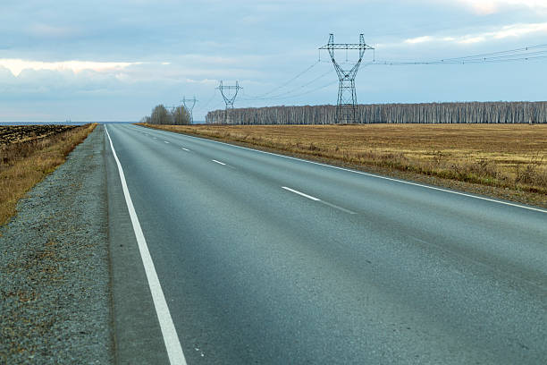 istock A long road with a power line in the background 2254615975