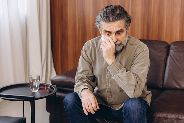 istock Crying older man wiping tears during therapy session 2254618569