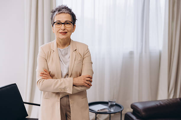 istock Confident mature female psychologist standing in office 2254618990