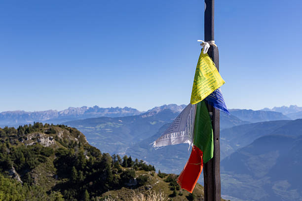 Prayer flags on a mountain peak in the Italian Alps