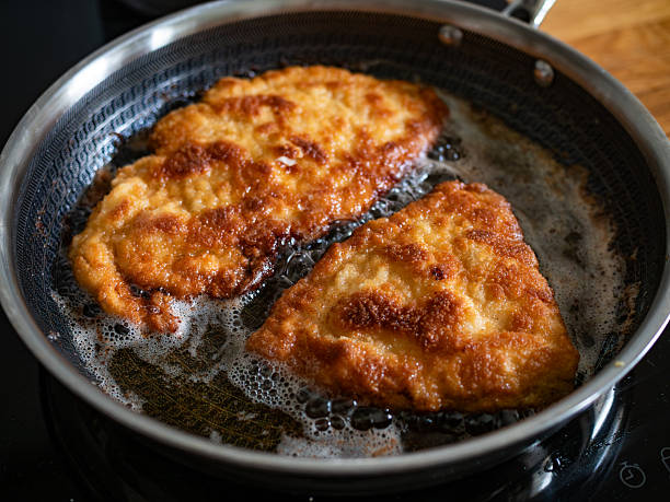 istock Frying crispy breaded chicken cutlets in frying pan, close-up 2254621170