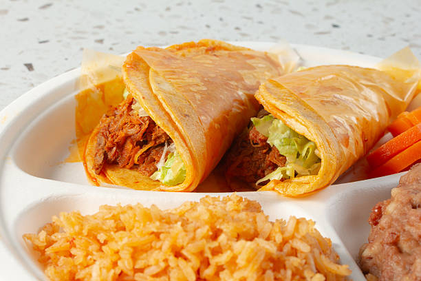 Authentic Mexican taco enchilada and tostada with refried beans and rice