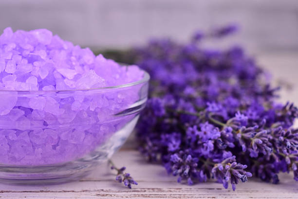 Aromatic purple bath salt with dry lavender, close-up.