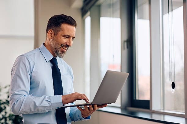 istock Happy businessman working on laptop in the office. 2254628524