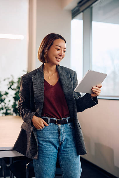 istock Happy Korean businesswoman using digital tablet while working in the office. 2254628548