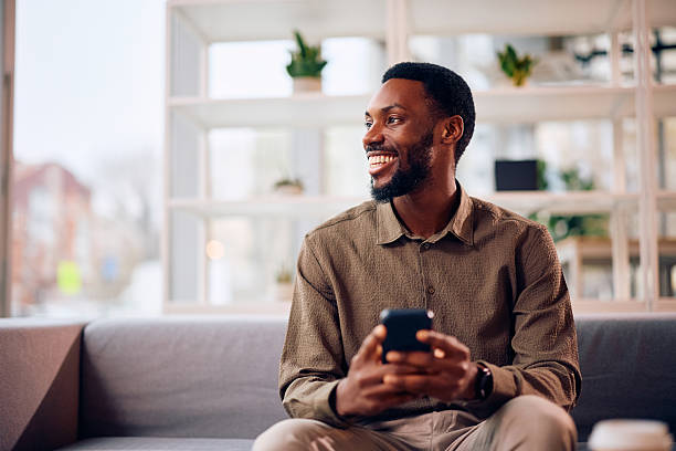 istock Happy black businessman using smart phone in the office. 2254628681