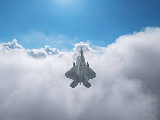istock F-22 jet aircraft flying over clouds. 2254630544