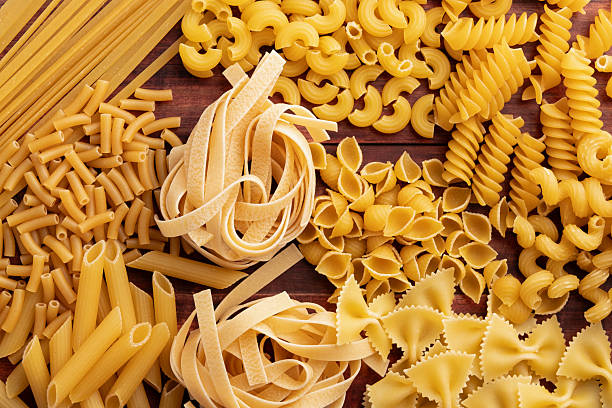istock Various pasta on a dark wooden background 2254633168