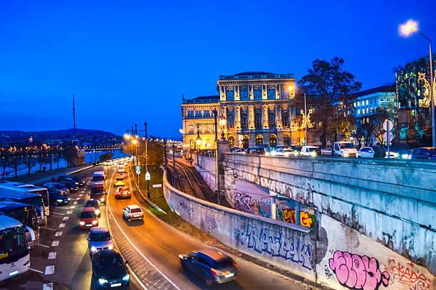 Budapest,Hungary-December 17th 2014:Night view of beautiful buildings and street traffic at Christmastime at Danube riverside street against twilight skies