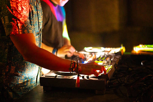 Two young dj's playing techno music on the summer night concert.