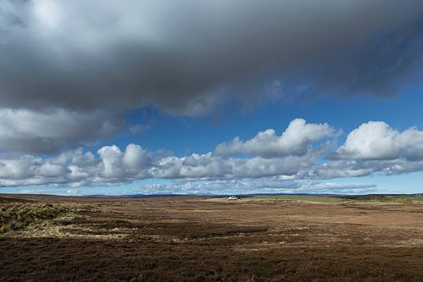 Peat or heather fields near Bettyhill Nothern Scotland in spring. Clouds