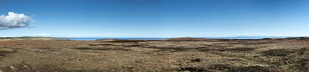 Peat or heather fields near Bettyhill Nothern Scotland in spring. Cloudsscape. Panorama