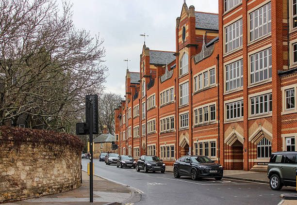 Oxford, United Kingdom - Dec 22, 2025: Beautiful facades of English buildings. Old British brick houses on a cloudy winter day.