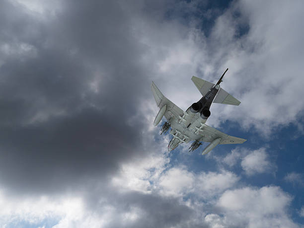 Modern fighter jet flying over clouds. F-4 Jet Fighters flying over clouds.