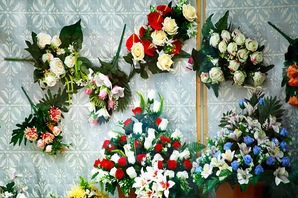 Multicolored display of a flower store, hanging from wall . Display of flower arrangements, full frame view suitable for backgrounds, store window. Galicia, Spain.