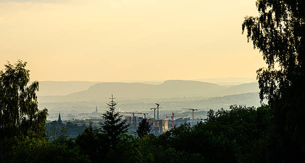 istock Distant city skyline viewed from hillside with trees. 2254637895