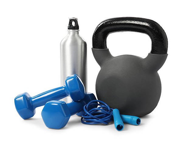 10-kilogram blue kettlebell and shiny dumbbells rest on a blue background, highlighting fitness and strength training equipment