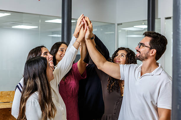 istock Team members celebrating success in a coworking space through a high five 2254639398