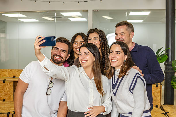 istock Group of professionals taking selfie in modern coworking space 2254639459