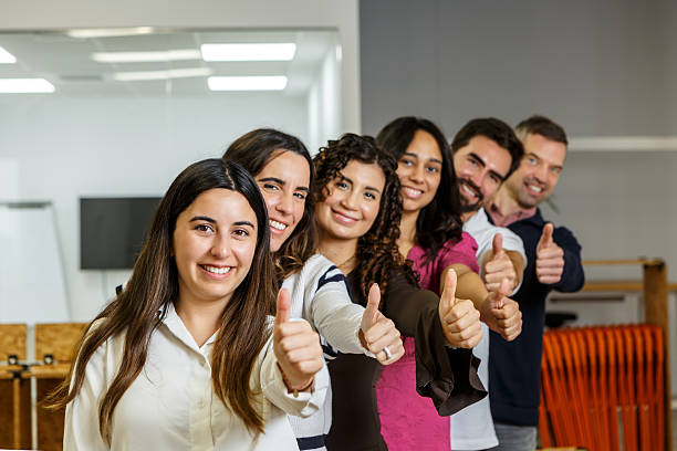 istock Team members showing thumbs up in modern coworking space 2254639769