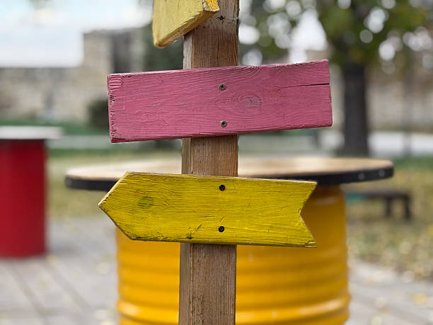 istock Colorful wooden arrows on post. Creativity, freedom, and joyful navigation concept 2254640416