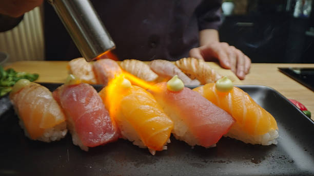 istock Chef torching fresh tuna and salmon sushi nigiri 2254641839