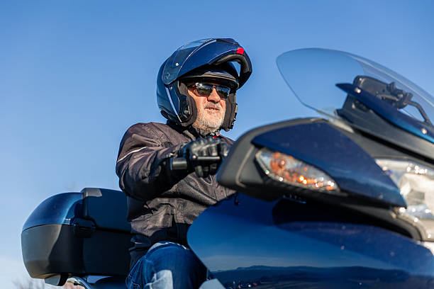 istock Senior man riding motorcycle enjoying open road trip 2254644228