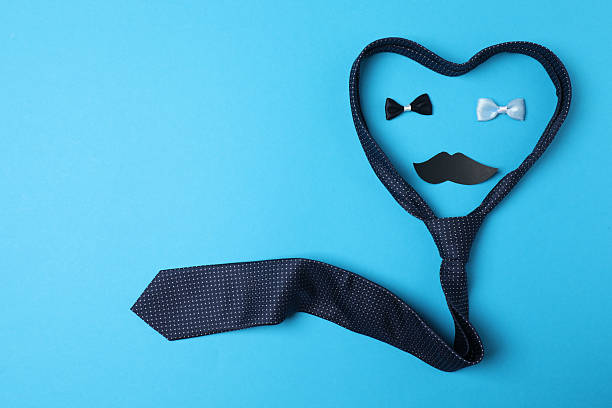 Postcard concept flatlay for Happy Fathers day with blue tie.