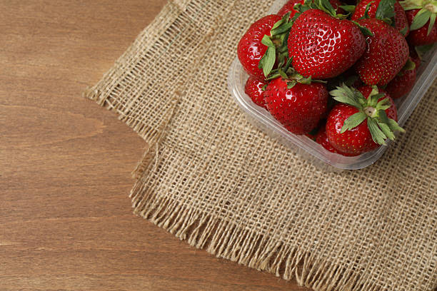 Strawberries in a tray on a wooden table