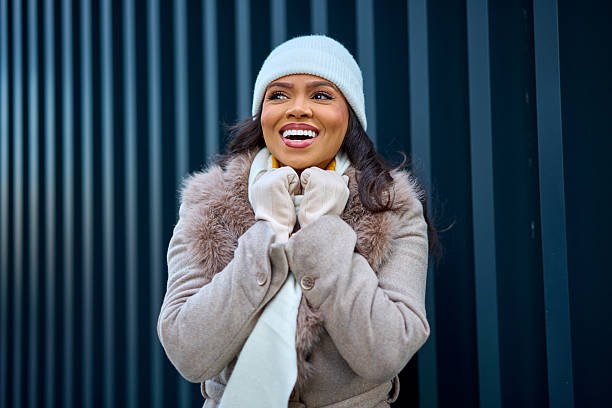 istock Young woman smiling in winter clothes 2254647268