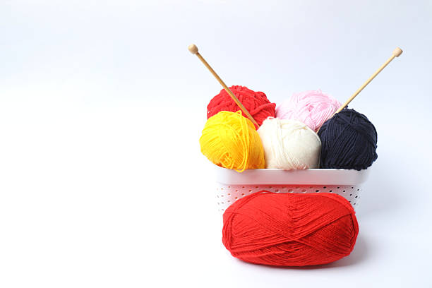 Knitting yarn and wool on an old table. Deep colors.