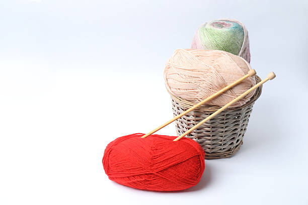 Various yarn, knitting needles on a white background, close-up