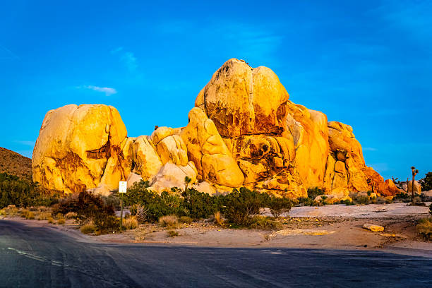 Rock formations glow under sunset light along Ryan Mountain Trail in Joshua Tree National Park California