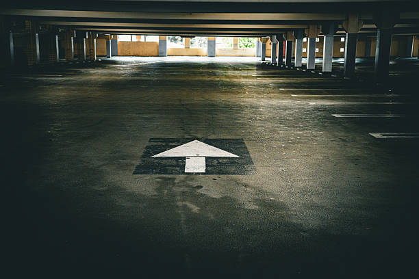 Interior of parking garage with car and vacant parking lot in parking building