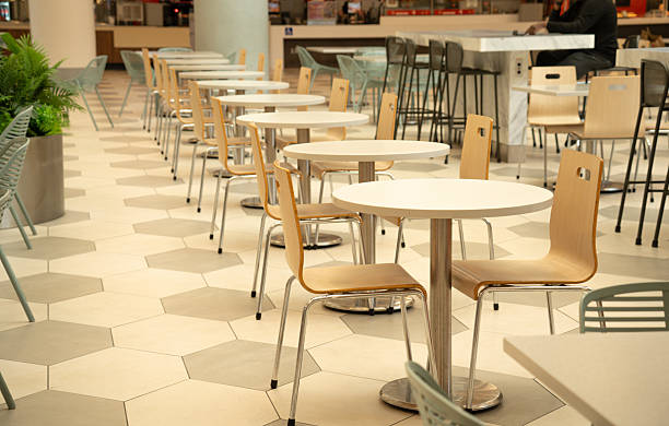 istock Modern cafe interior with empty tables and chairs, clean and bright seating area 2254651702