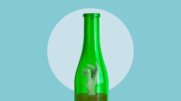 istock Alcohol Addiction Concept - Human Hand Trapped Inside Green Glass Bottle, Dependency and Substance Abuse 2254653868