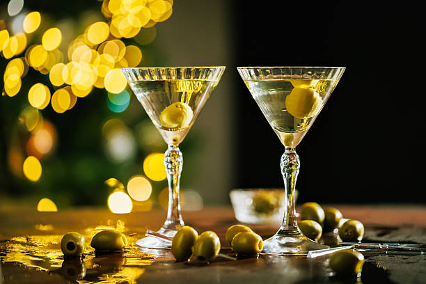 istock Two martini glasses with olives and sparkling lights 2254654182