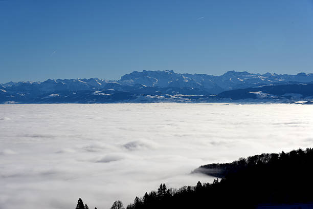 Several Hills in Switzerland (Canton Zurich) in fog. Seen from the Uetliberg hill and captured during winter season.