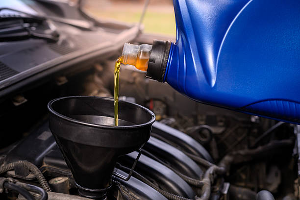 istock Pouring oil into a car engine 2254655311