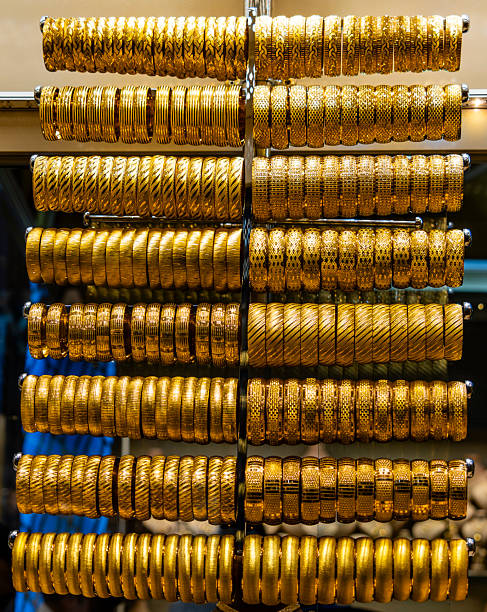A display of various types of gold jewelry including gold chains, collars, watches and various others.