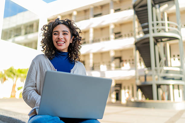 istock Young student woman using laptop at university 2254663833