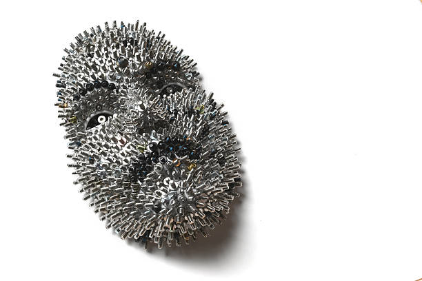 A face made entirely of screws from computer hard drives. A visual analogy for Artificial Intelligence.