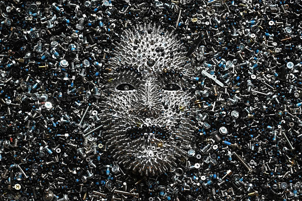 A face made entirely of screws from computer hard drives. A visual analogy for Artificial Intelligence.
