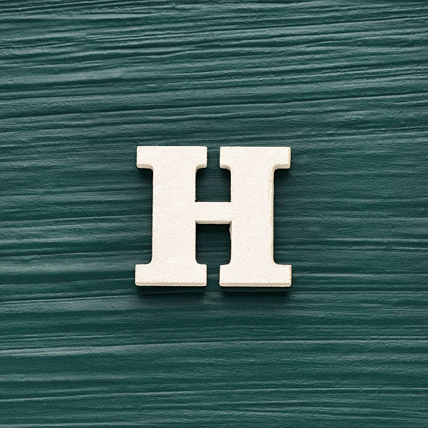 istock Capital letter H, White letter on a rustic dark green background 2254667406