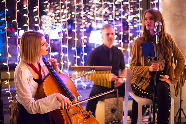 Rock group playing on the concert in the night club.