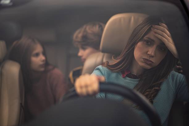 istock Stressed mother driving car with children experiencing burnout 2254669223